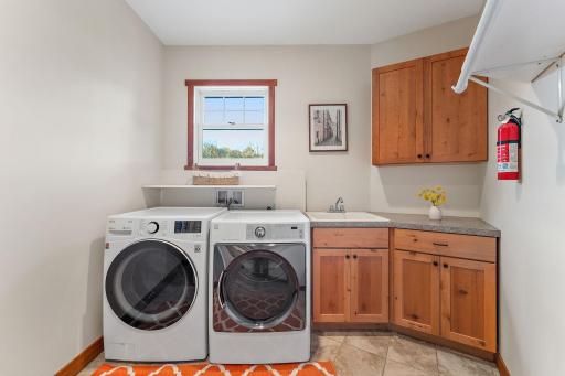 The main level laundry room offers lots of storage and a utility sink just off the garage entrance.