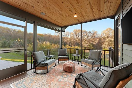 The screened in porch is located right off the kitchen and steps to the deck, and the patio/yard space