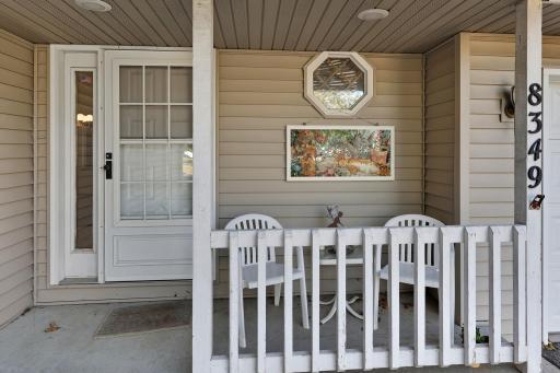 Front entrance has porch for relaxing and enjoying the sites and sounds of the neighborhood