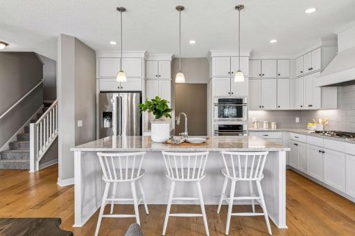 The kitchen offers an abundance of great storage, Silestone countertops, stainless-steel appliances and under-cabinet lighting.