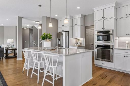 The entrance from garage/mudroom is to the left of the stove.