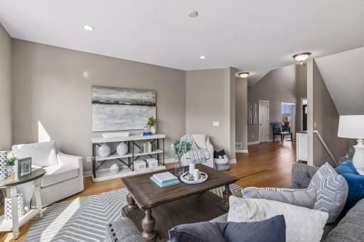 Looking back to the front of the home. The hallway to the left of the living room leads to the main floor guest suite.