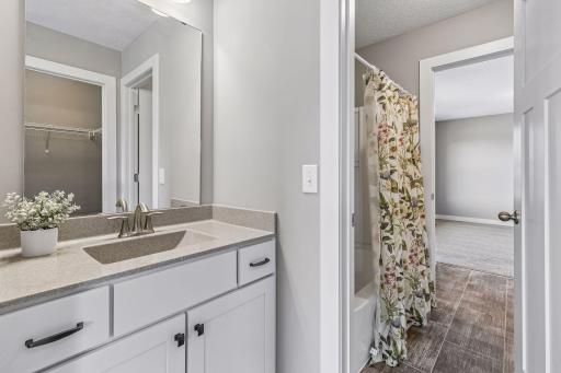 Jack and Jill bathroom shared between bedroom #3 and 4 with a vanity on each side and a separate toilet room.
