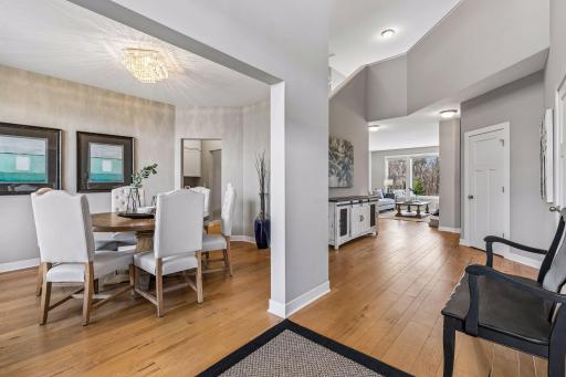 Upon entering the home, you are greeted by this spectacular entryway with gorgeous, engineered hardwood flooring. Enjoy a formal dining room for entertaining. Office, 1/2 bathroom and coat closet to the right.