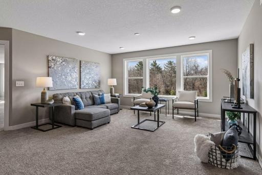 Head upstairs where you'll find this spacious loft with recessed lighting, four large bedrooms and the laundry room.