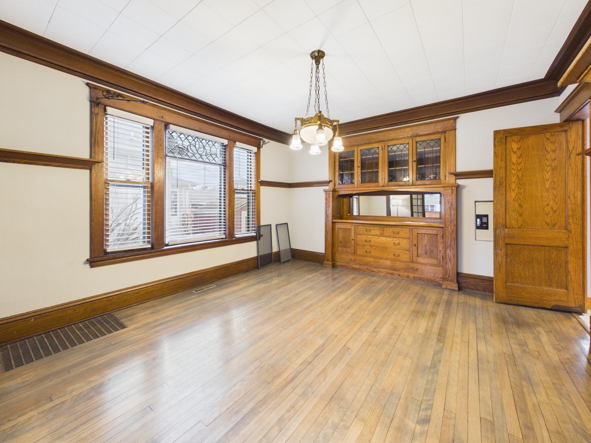 Dining room - original built-in buffet, vintage chandelier, decorative windows - 3032 Longfellow Ave., Minneapolis