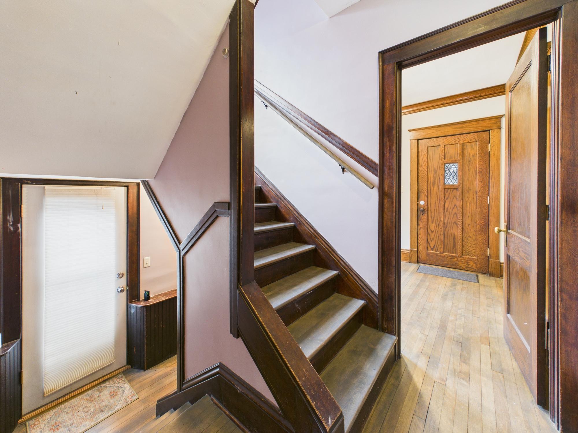 Staircase on main level. Foyer and front door ahead, side entry and landing on left side - 3032 Longfellow Ave., Minneapolis