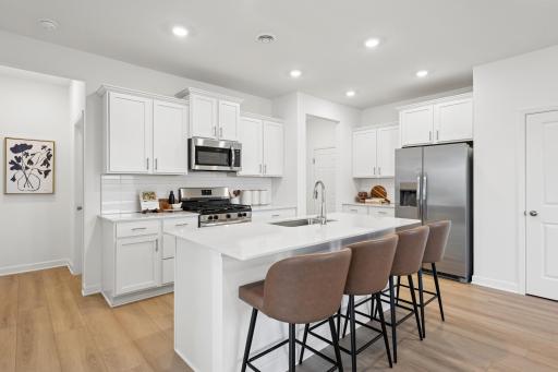 (Photo of decorated model, actual homes colors and finishes will vary) Very spacious kitchen with an abundance of cabinet space