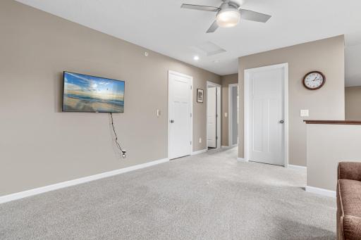 Expansive upper level showing the spacious loft, guest bedroom, and full bath. Large windows provide ample light, while the layout offers a private guest wing and extra storage. A perfect secondary living zone or quiet retreat!