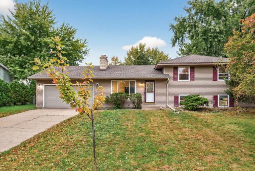 Photo for 10616 Arrowhead Street NW, Minneapolis, MN 55433 - listing #6803818 10616 Arrowhead St NW - Classic curb appeal with an attached garage and a spacious front yard.