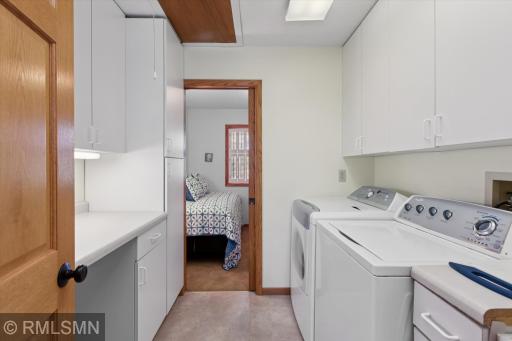 Main floor laundry with plenty of cupboards and folding counter