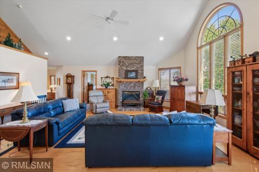 Living Room with vaulted ceilings, stone fireplace, beautiful windows overlooking the valley.