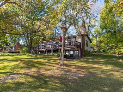 Beautifully maintained yard sloping toward the lake, highlighting the home's multi-level design.