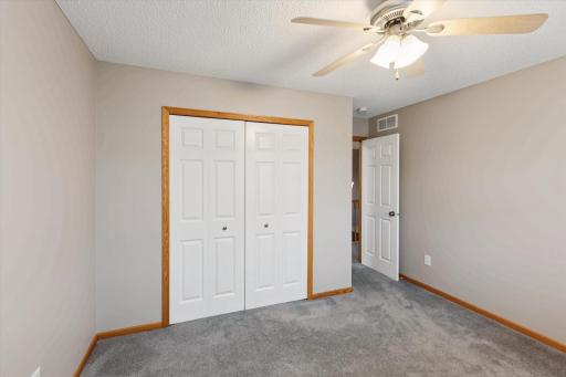 Bedroom with large closet and ceiling fan