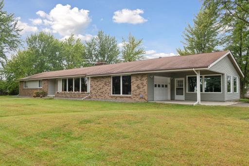 Oversized 1 Car Attached Garage w/Carport & 3 Season Porch. Plenty of Additional Parking in the 2 Out Buildings.