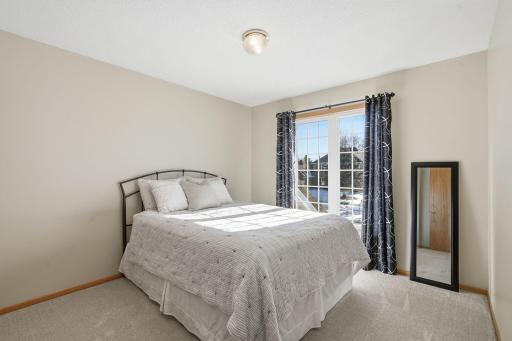 One of two additional bedrooms on the upper level sits on the front of the home.