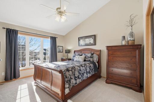 The primary suite offers vaulted ceilings, a walk in closet and an attached remodeled bathroom.