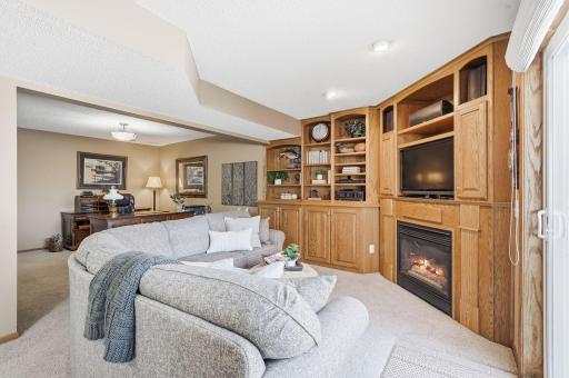 Warm up by your second gas fireplace in the home surrounded by built ins for decor and storage.