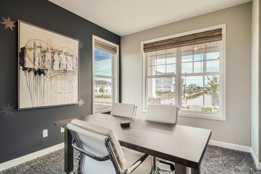 Photo is of the model. The home features a main level study. Perfect for those working from home or who want an office space to stay organized.