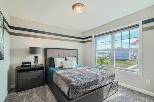 Photo is of the model. Another one of the secondary bedrooms that comes perfectly sized with a spacious closet.