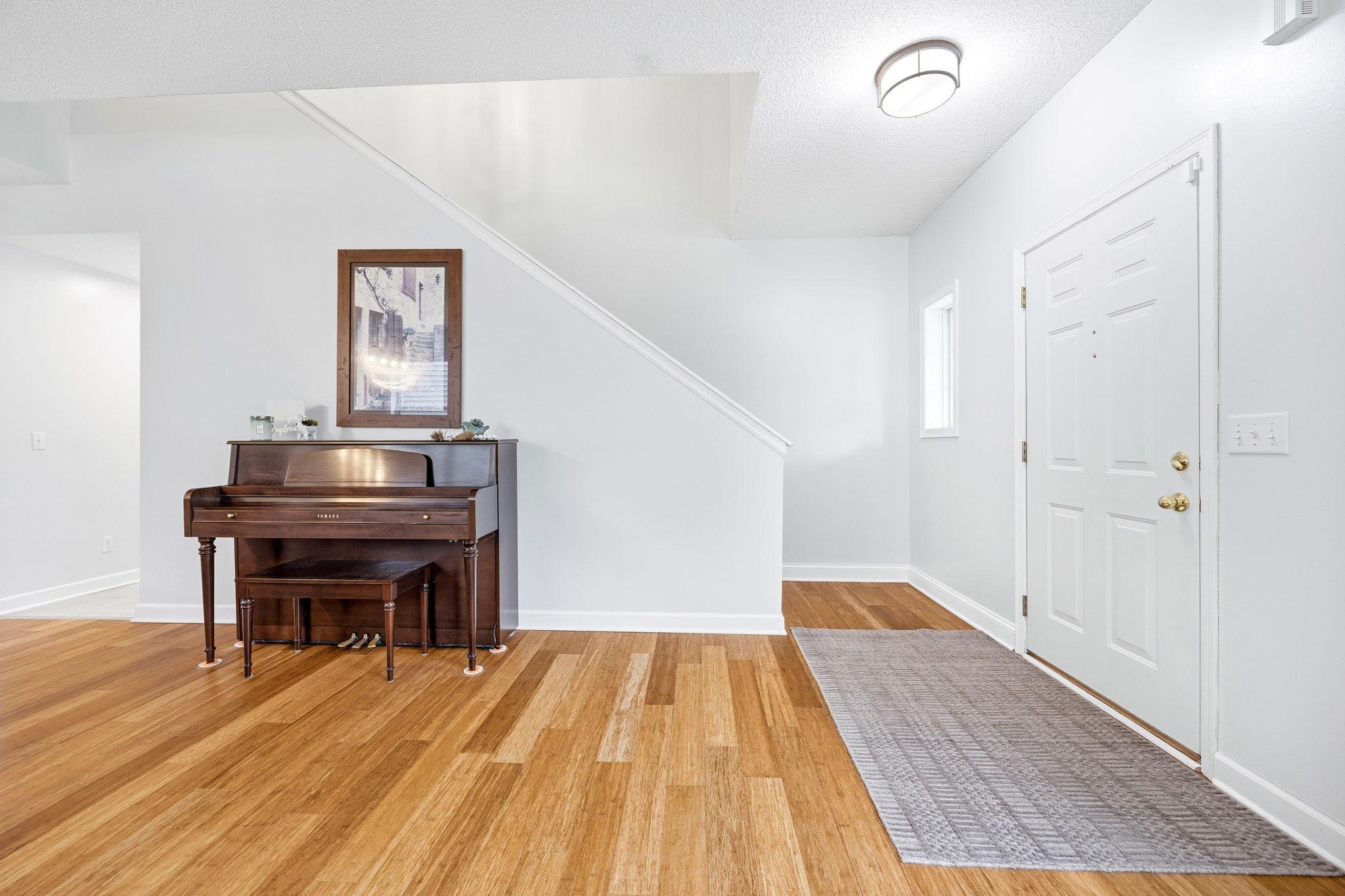 High Ceilings and beautiful stairway to upstairs