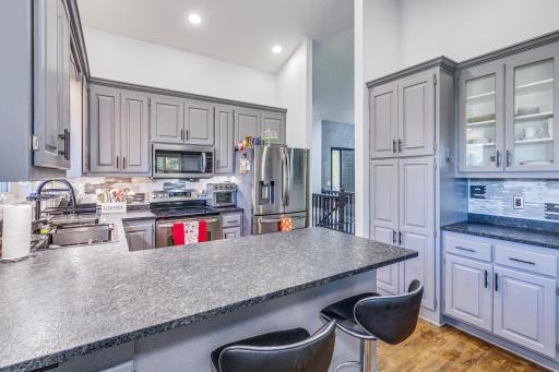 This home features lake views and has been beautifully updated throughout. The Kitchen features custom cabinets, a built-in desk, a beautiful backsplash, and stainless steel appliances.