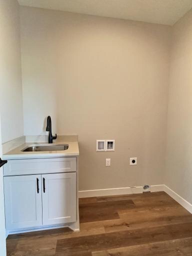 The laundry room is conveniently located outside the primary bedroom for ease of use.