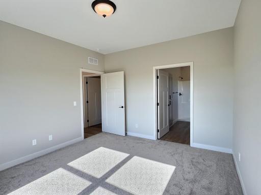 2nd photo of the primary showing the door the private bath.