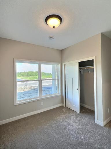 The first bedroom is located at the front of the home, overlooking the front porch and yard, making it an ideal space for a home office.