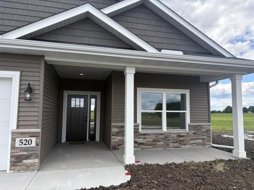 The covered front porch is ideal for relaxing and watching the activity of the neighborhood or just saying hello to those who pass by.