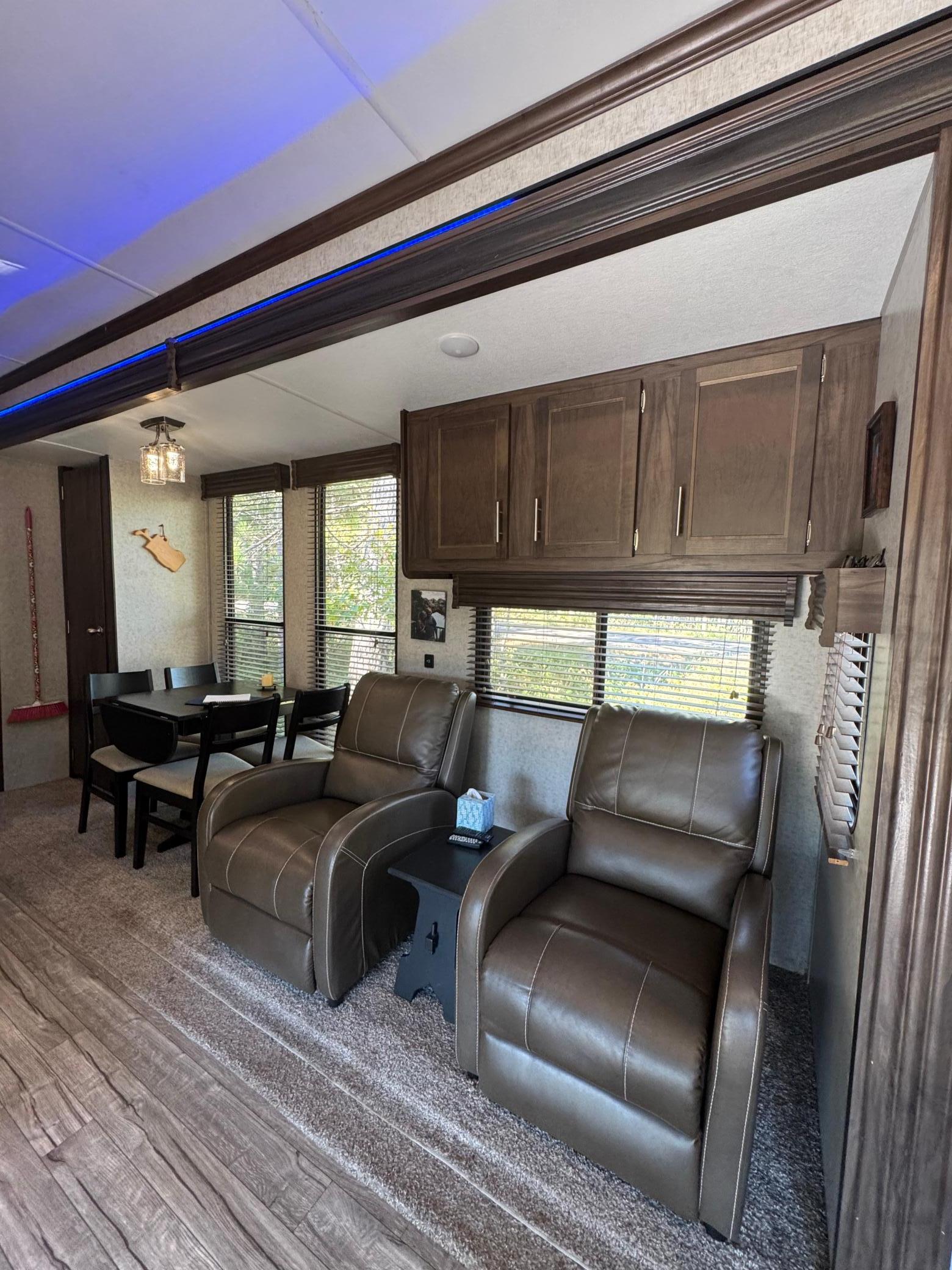 Dual letter espresso recliners in one slide out - you ulna see the dining table for four in the background