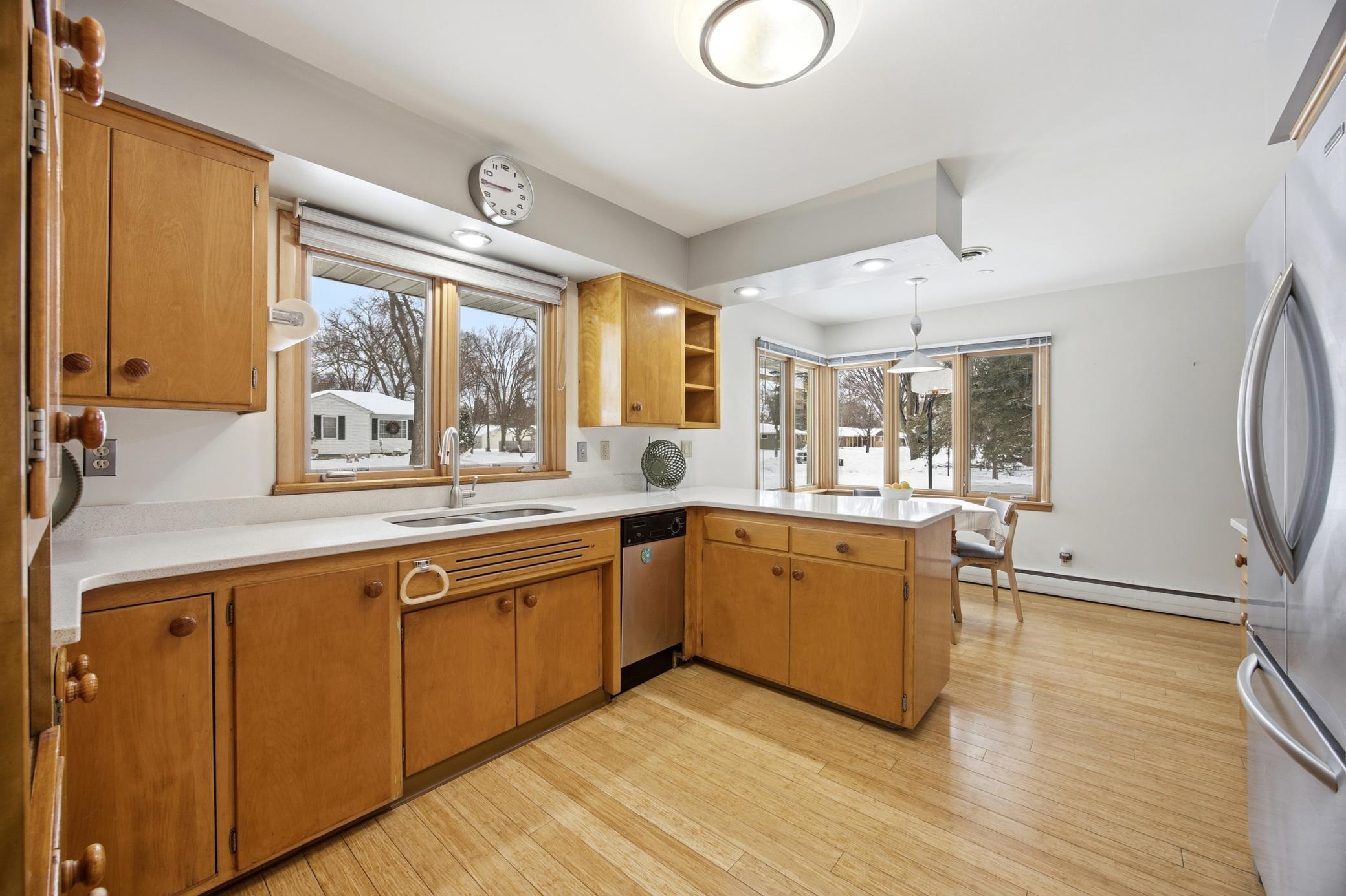 Kitchen Featuring Bamboo floors, a gas range, Corian countertops, and midcentury cabinets!