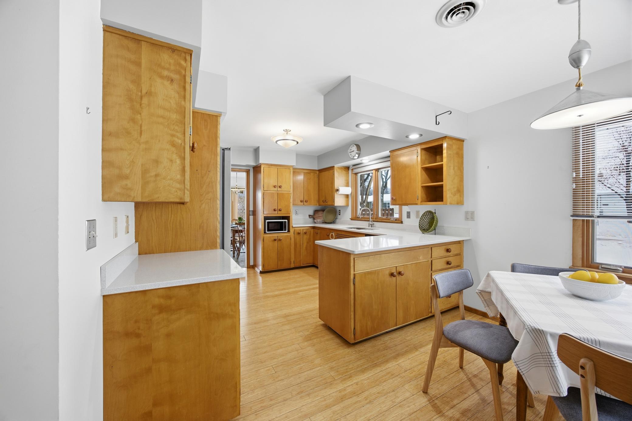 Kitchen Featuring Bamboo floors, a gas range, Corian countertops, and midcentury cabinets!