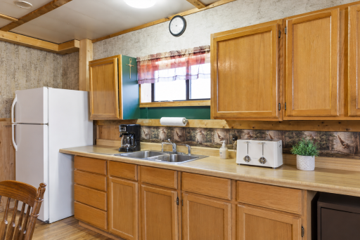 Functional kitchen with wood cabinetry, generous counter space, and everyday convenience for easy lake life living.