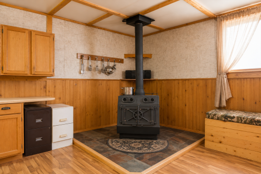Wood stove adds cozy ambiance and supplemental heat, making this log home inviting through every season.