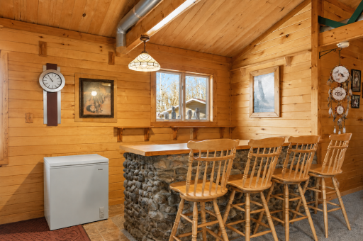 Rustic dining and bar area creates a charming gathering spot for meals, coffee, games, and entertaining at the cabin.