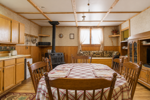 Open dining area near the wood stove brings warmth, comfort, and classic northern Minnesota cabin character.
