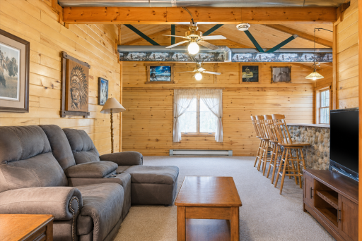 Cozy log home living room with warm wood finishes, open gathering space, and a relaxed cabin feel perfect for weekends at the lake.