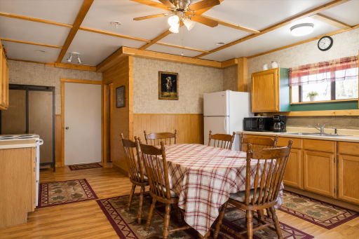 Dining area with cabin-style charm provides space to gather, share meals, and enjoy the peaceful Aitkin lake lifestyle.