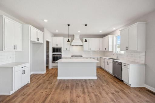 Upgraded Signature Kitchen includes: Double wall oven, gas cooktop, microwave w/air fryer and dishwasher.