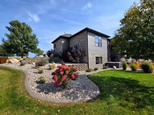 Beautiful landscaping with concrete edging around extensive landscaping