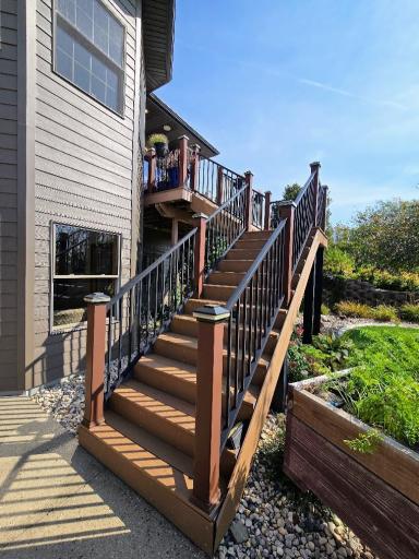 Composite stairway leading down to aggregate concrete patio or up to the composite deck.