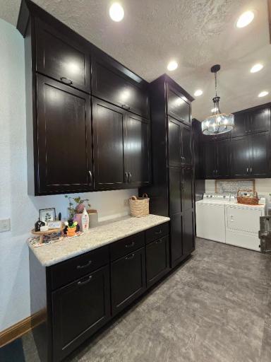 New laminate countertops, Commercial grade LVP flooring, custom made cabinets by Country Cupboards,-pullout hampers, cleaning closet, wrapping paper center..