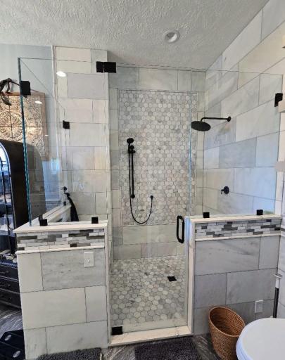 Custom made shower with double shower heads and bench.