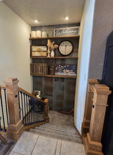 Stairway to basement - wood & iron railing fit the decor of the house