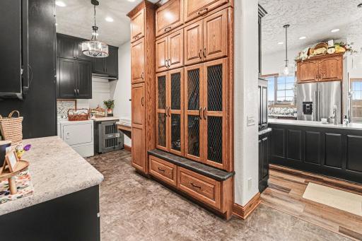 Classy laundry room with custom made lockers & cabinets-love the extra touches
