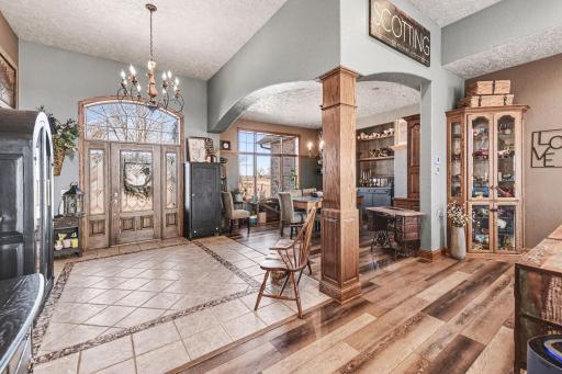 Grand front door entrance with detailed/accented ceramic tile flooring,attractive chandelier, 12 foot ceilings, arched doorways and wooden pillars. Welcome to your "dream home".