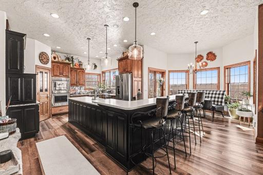 Updated kitchen with custom made cabinets by Country Cupboards, newer stainless steel appliances, cambria countertop, & walk in pantry.