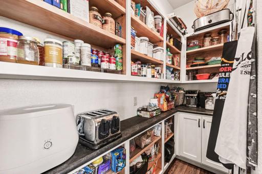 9 x 3.5 pantry. So much storage! Plenty of storage shelves, countertops with 3 outlets, & cabinets with pullouts.