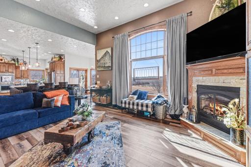 Kitchen has open concept to living room area with plenty recessed lighting & natural lighting-let's not forget the cozy gas fireplace!